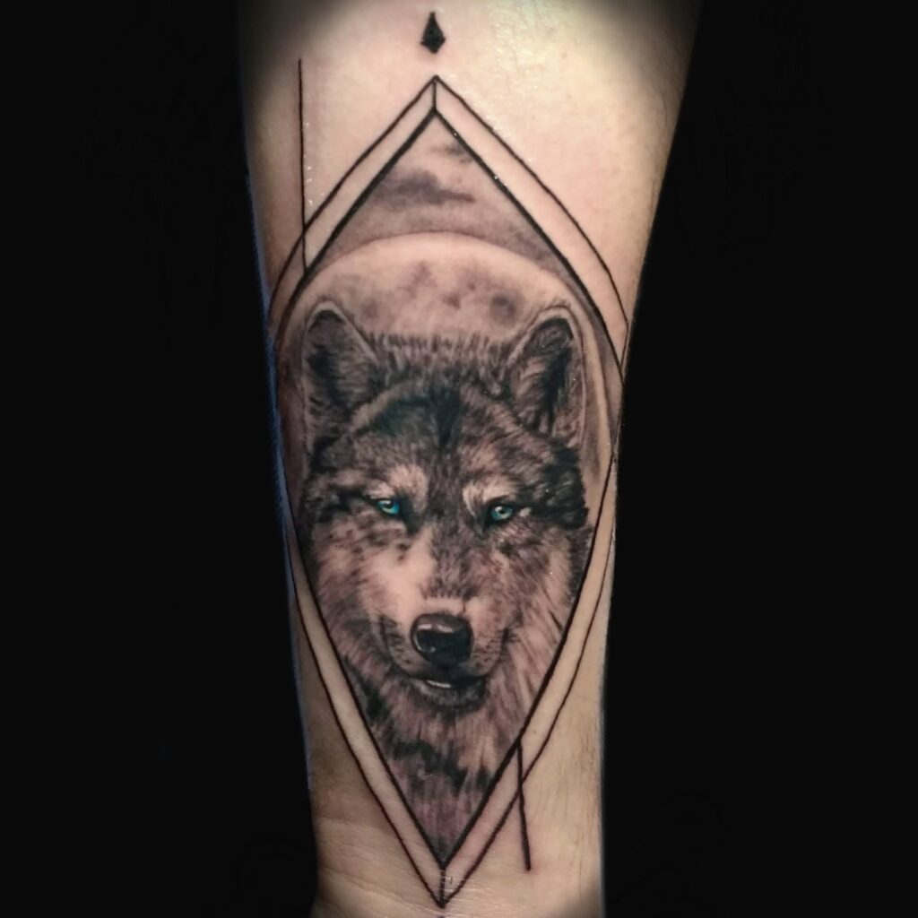 Black and grey wolf tattoo with geometric linework by Uppercuts Tattoo Shop, Maple Ridge BC